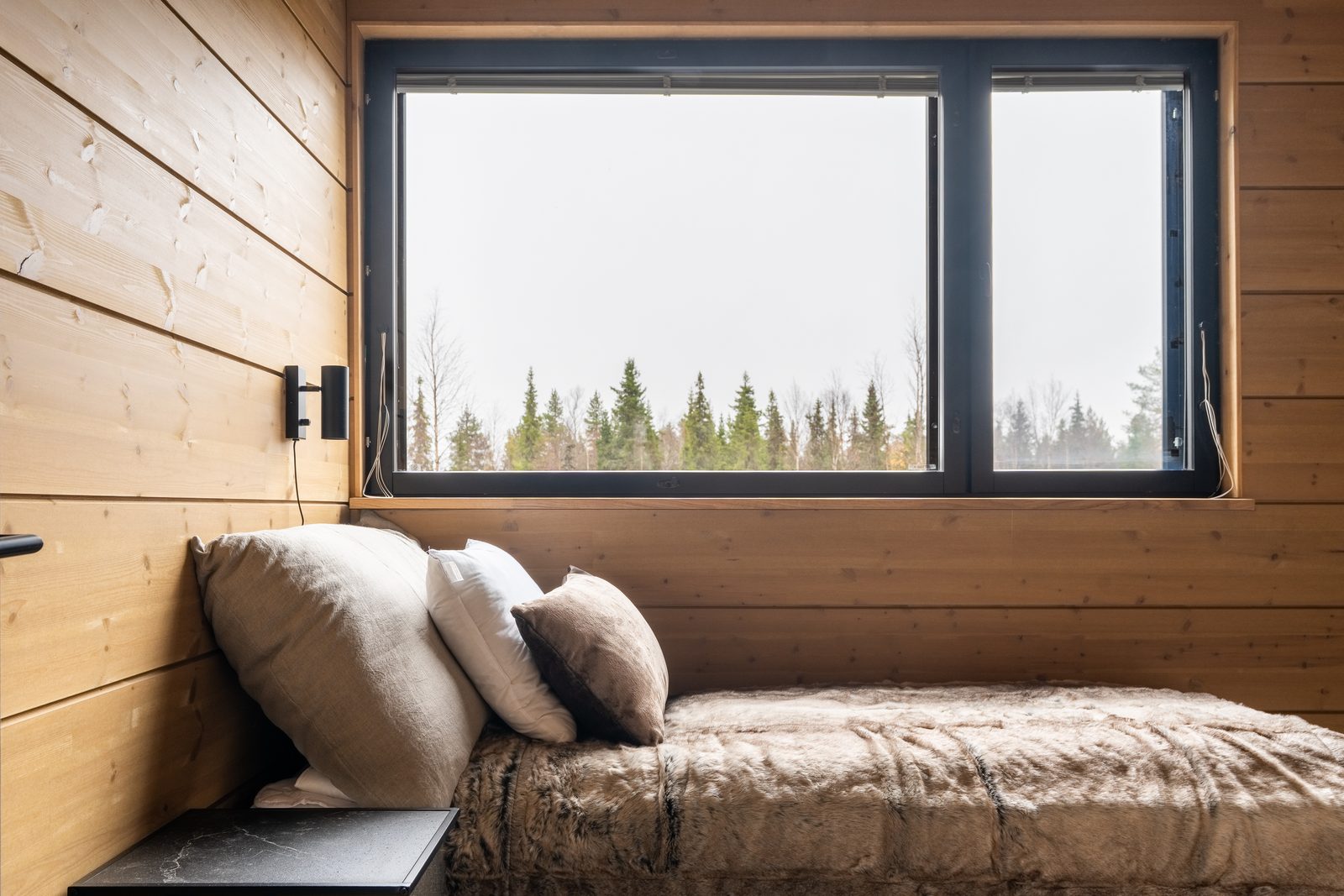The upper landing with a daybed made up under the window and cushions along the wall.